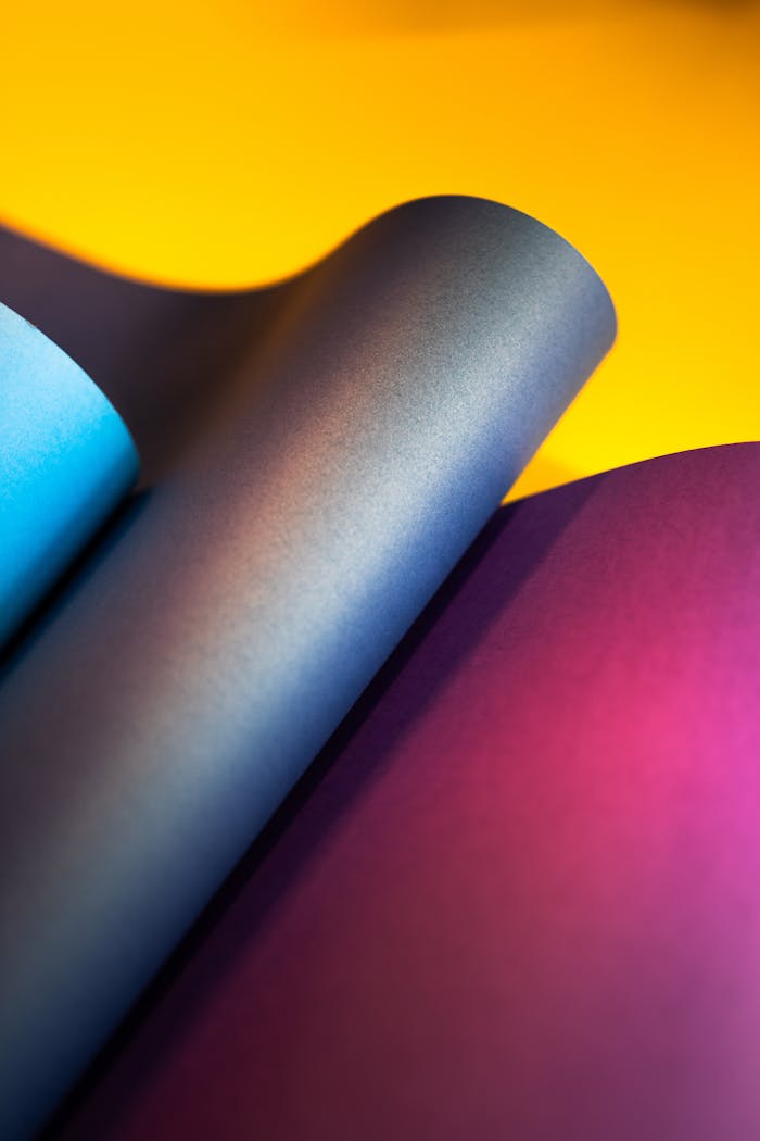pexels-photo-19291723 Close-up of colorful overlapping paper sheets creating a dynamic abstract pattern.