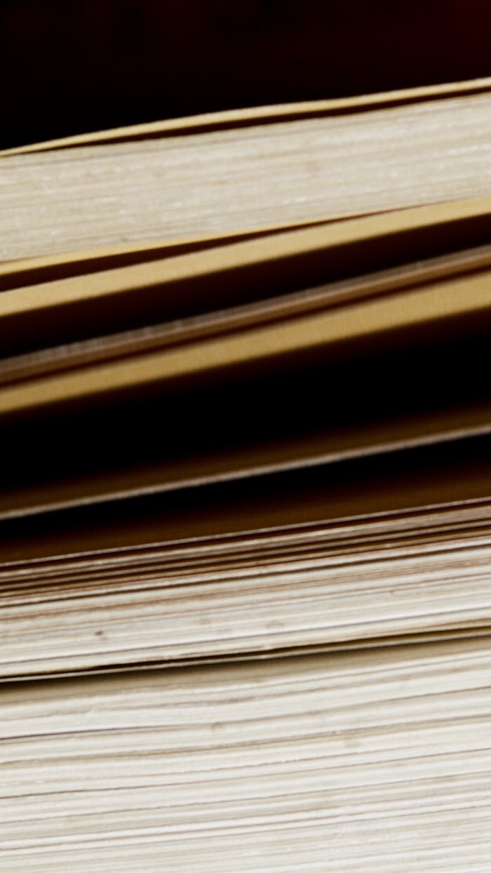 pexels-photo-7233375 Detailed close-up shot of vertically stacked vintage hardcover books, showcasing texture and edges.